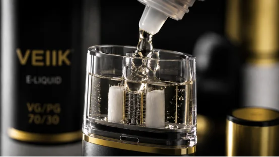 Filling a clear VEIIK vape pod with e-liquid